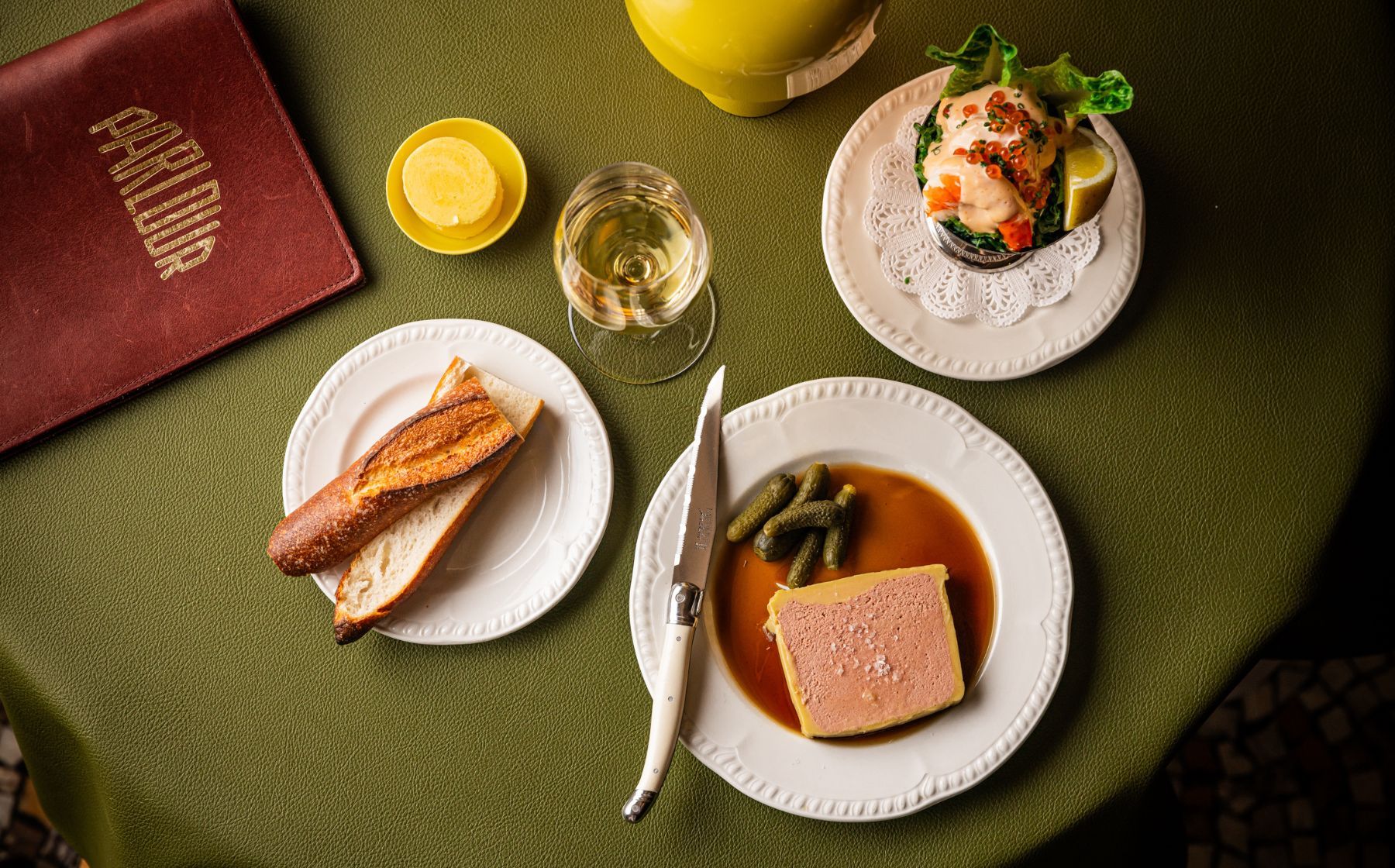 Parlour table with parfait, baguette, wine and seafood
